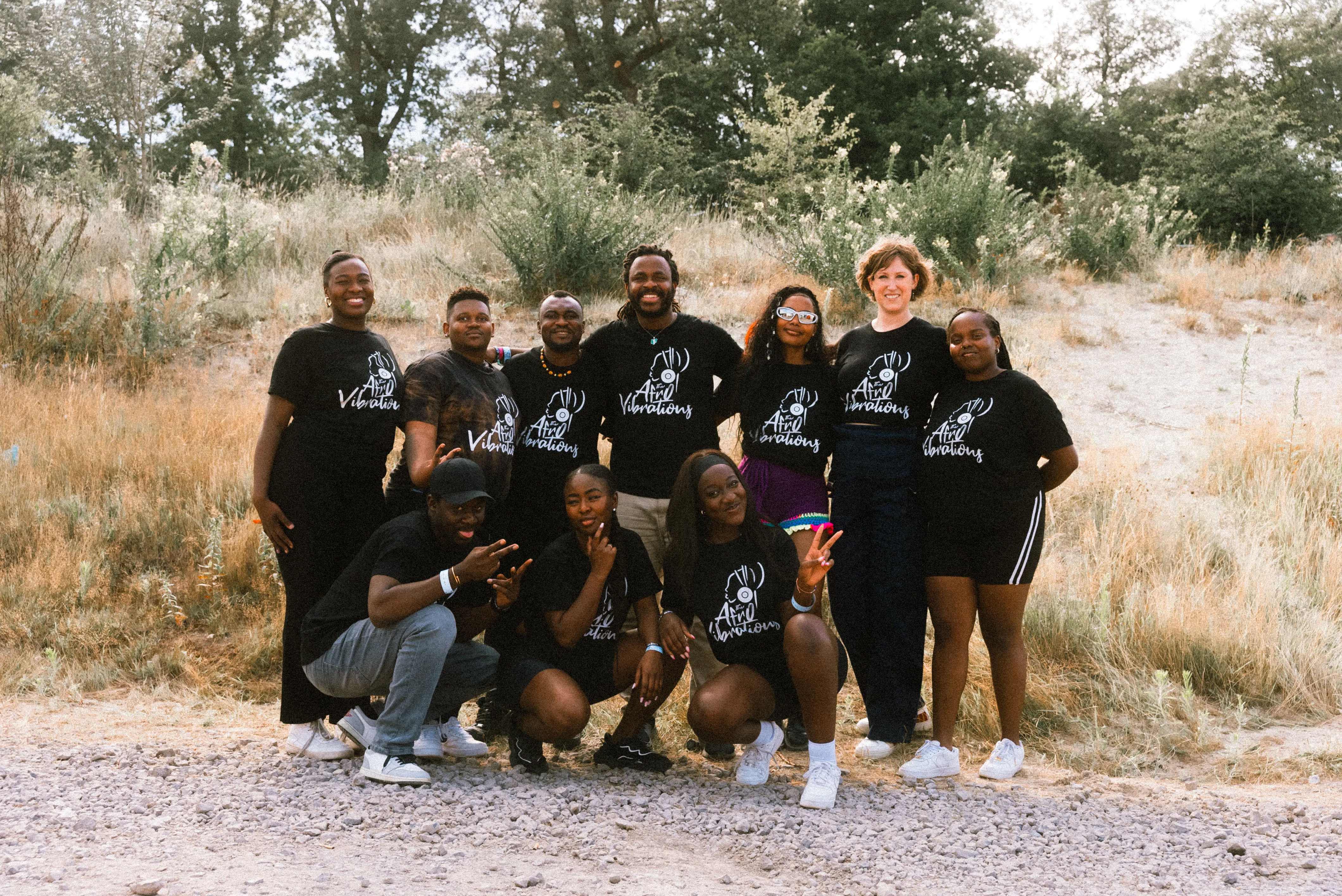 AfroVibrations Soundsystem crew standing together outdoors in branded shirts